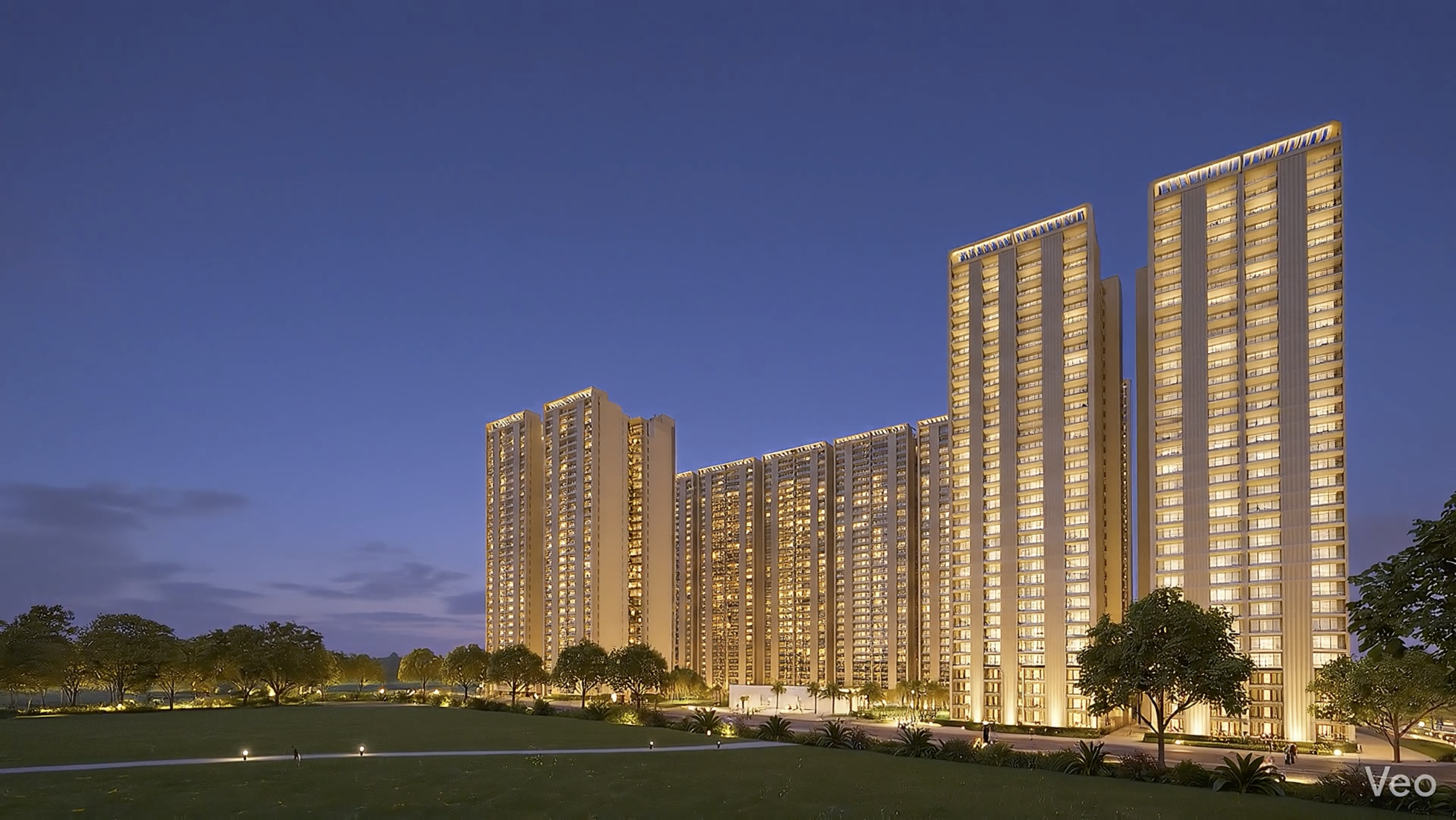 Forbes Fab Luxe Residences tower cluster at dusk with warm golden lighting and landscaped lawn